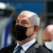 Israeli Prime Minister Benjamin Netanyahu attends while mask-clad the inauguration of a COVID-19 coronavirus rapid testing centre at Ben Gurion International Airport in Lod on November 9, 2020. - Netanyahu inaugurated the rapid coronavirus testing centre at Israel's main international airport, meant to ease travel in and out of the country. The new set-up allows travellers to give a sample at the terminal and have it analysed at an on-site lab, with the result ready in 5 1/2 to six hours as the traveller waits, costing 135 shekels ($40). (Photo by ATEF SAFADI / POOL / AFP)