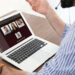 Man having video chat with colleagues at table in office, closeup