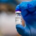 Bucharest, Romania - January 5, 2021: Shallow depth of field (selective focus) image with details of the Pfizer BioNTech vaccine in the hand of a medical worker.