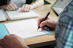 Manager Working As Banking Broker With Old Man Signing Contract