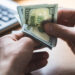 Businessman is counting dollars banknotes, business and financial background