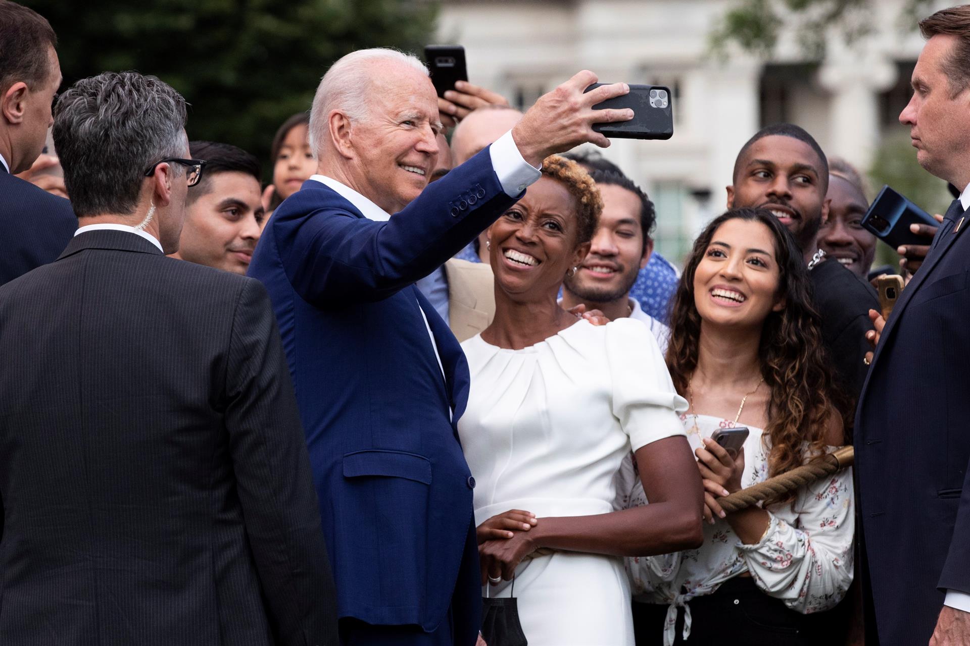 El presidente Joe Biden se toma una foto junto a un grupo de personas tras el evento el La Casa Blanca.