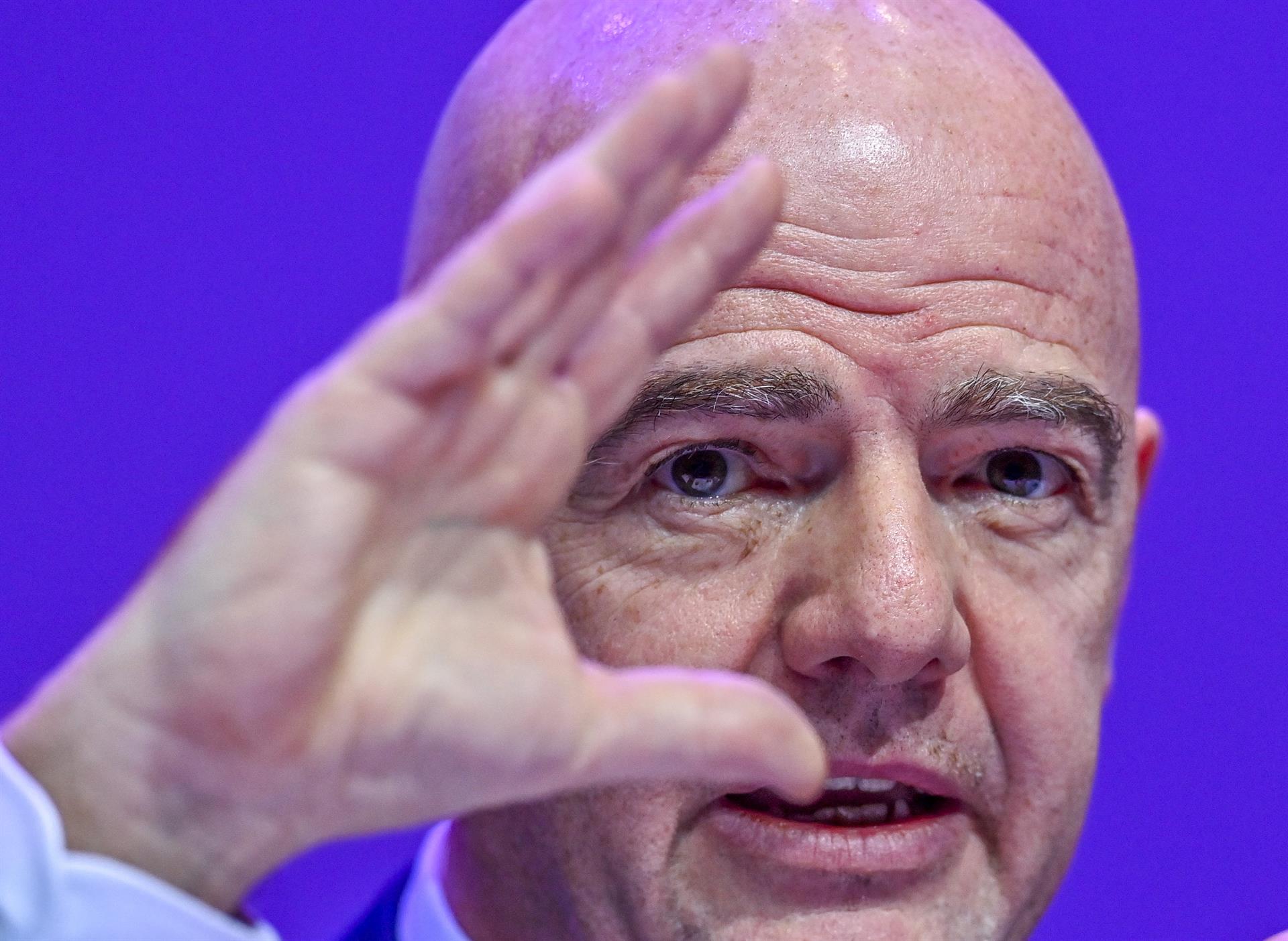 Gianni Infantino gesticula con su mano izquierda frente a su rostro, mientras habla