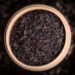 Top view of dried black tea in bamboo box