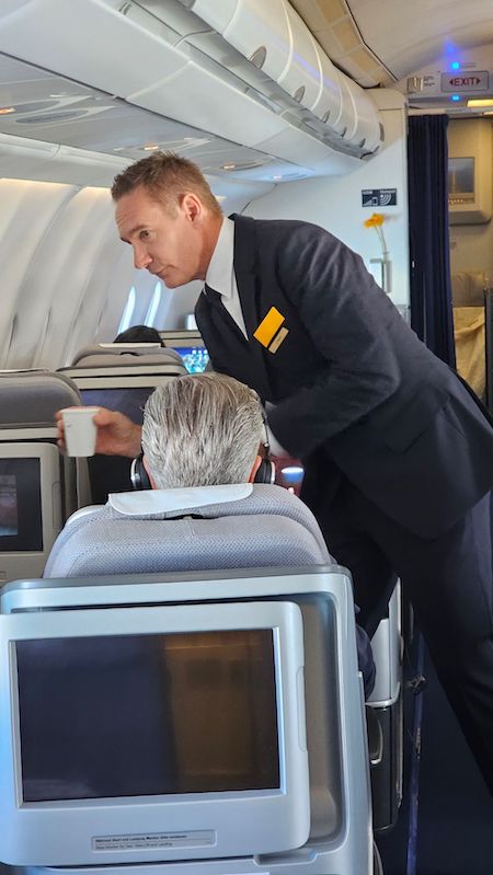 El CEO de Lutfthansa, Jesn Ritter, sirviendo bebeida a un pasajero.